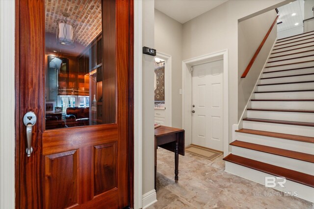 entrance foyer featuring brick ceiling