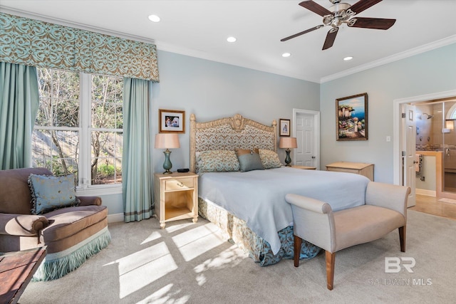 bedroom featuring ensuite bath, ceiling fan, light carpet, and ornamental molding