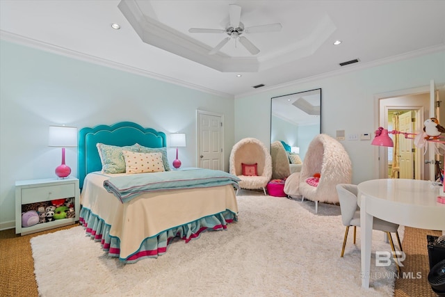 carpeted bedroom featuring ceiling fan, ornamental molding, and a tray ceiling