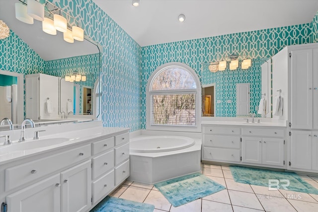 bathroom featuring a tub to relax in, tile patterned flooring, and vanity