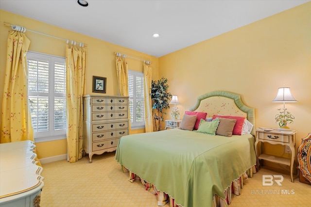 carpeted bedroom with multiple windows