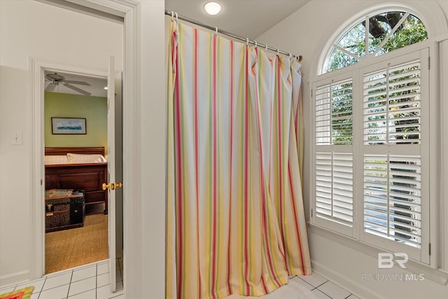 bathroom with tile patterned floors and ceiling fan