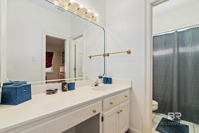 bathroom featuring tile patterned flooring, vanity, and toilet