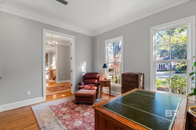 living area featuring ornamental molding, plenty of natural light, hardwood / wood-style floors, and a notable chandelier