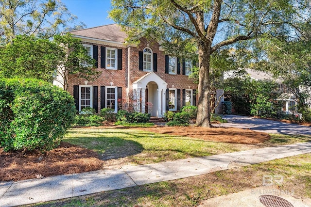 colonial-style house with a front yard