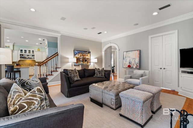 living room featuring light hardwood / wood-style floors and ornamental molding