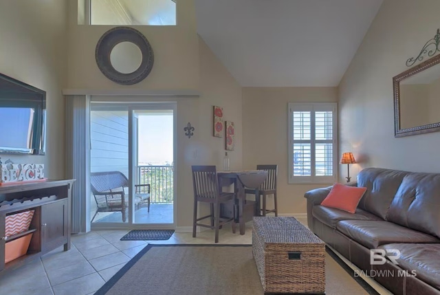 living room with high vaulted ceiling and light tile patterned flooring