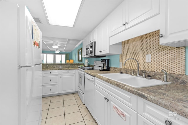 kitchen with white appliances, white cabinets, sink, ceiling fan, and light tile patterned floors