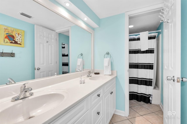 bathroom with tile patterned floors and vanity