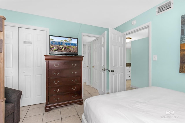 bedroom featuring light tile patterned flooring and a closet