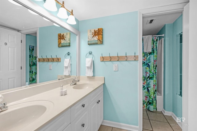 bathroom with shower / bath combo with shower curtain, tile patterned flooring, and vanity