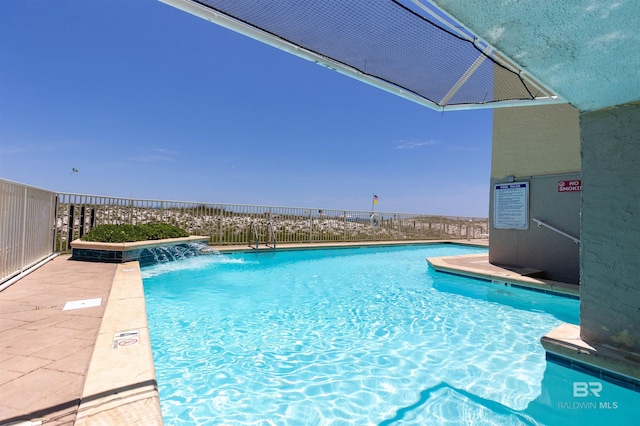 view of pool with pool water feature