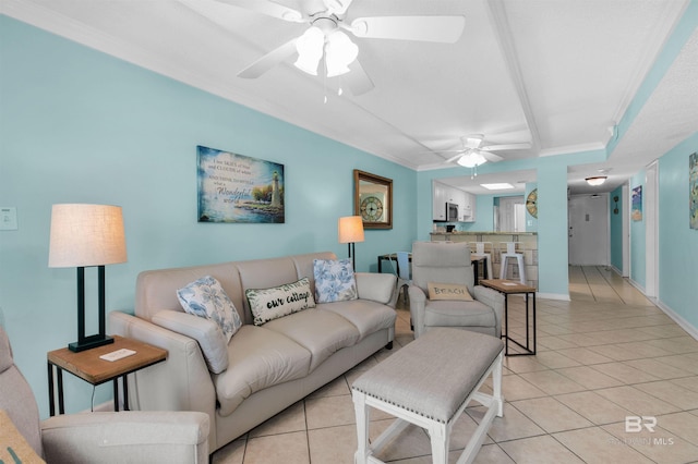 living room featuring light tile patterned floors, ceiling fan, and ornamental molding