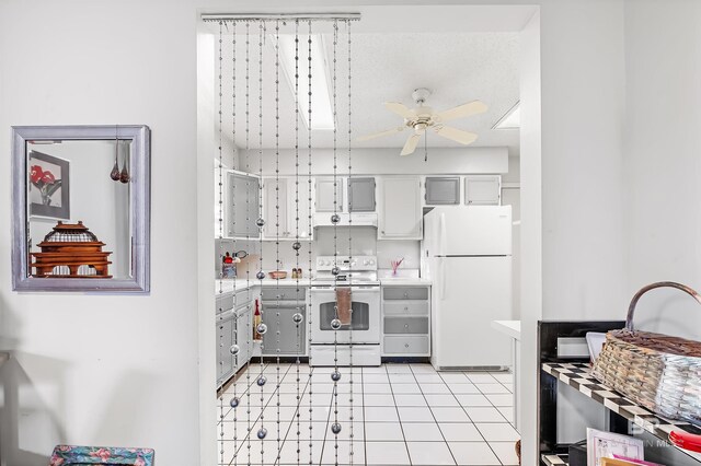 526 W Ariel Ave, Foley, AL 36535 - kitchen featuring light tile patterned flooring, gray cabinetry, ceiling fan, and white appliances