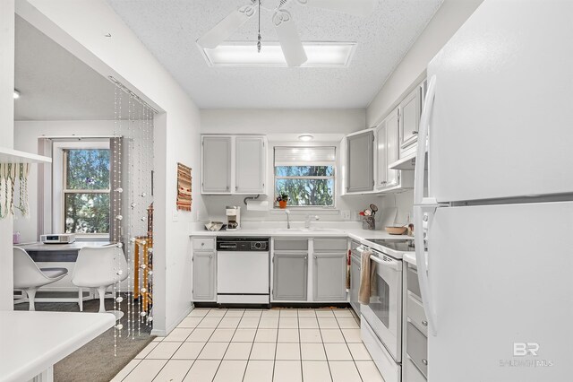 526 W Ariel Ave, Foley, AL 36535 - kitchen featuring sink, gray cabinetry, a textured ceiling, light tile patterned floors, and white appliances