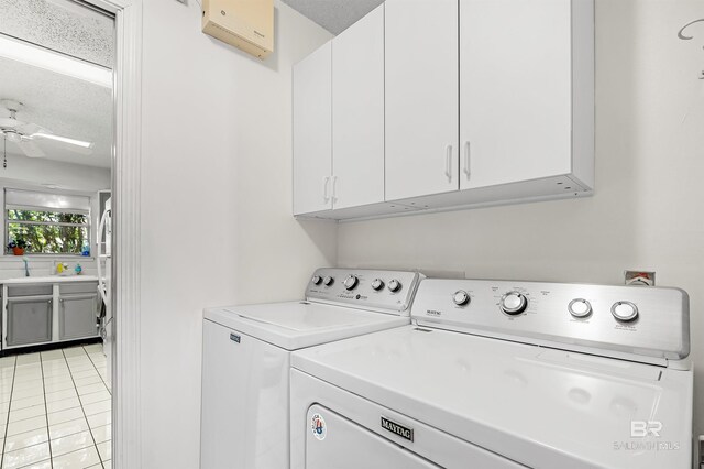 526 W Ariel Ave, Foley, AL 36535 - clothes washing area featuring light tile patterned floors, ceiling fan, cabinets, a wall mounted AC, and washer and dryer