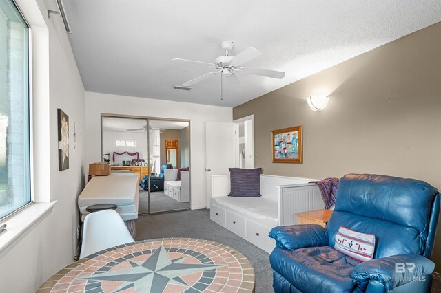526 W Ariel Ave, Foley, AL 36535 - living area with ceiling fan and dark carpet