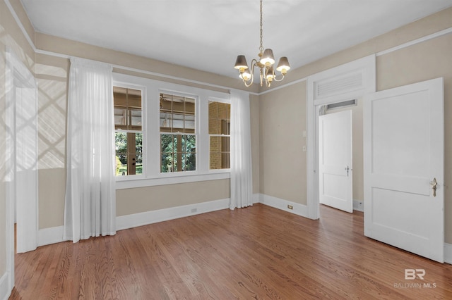 1706 Hunter Ave, Mobile, AL 36604 - empty room featuring a chandelier and wood finished floors