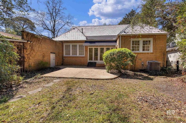 1706 Hunter Ave, Mobile, AL 36604 - rear view of house with brick siding, a patio area, and a lawn