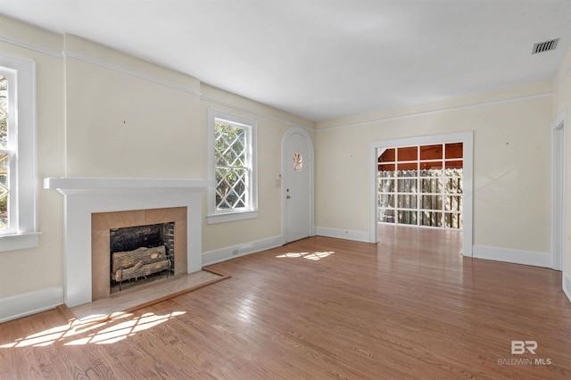 1706 Hunter Ave, Mobile, AL 36604 - unfurnished living room with a fireplace and wood finished floors