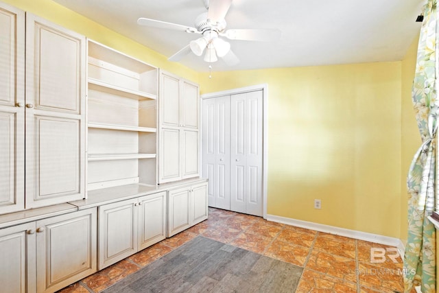 unfurnished bedroom with ceiling fan, a closet, and lofted ceiling