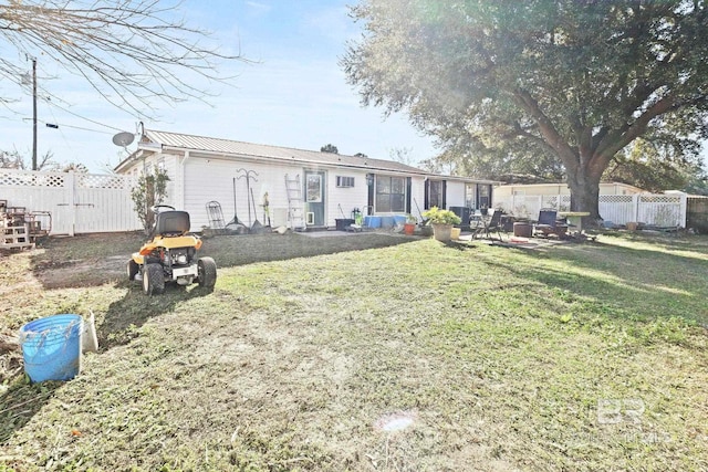 back of property with a yard and a patio