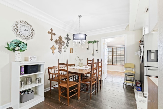 dining area featuring crown molding