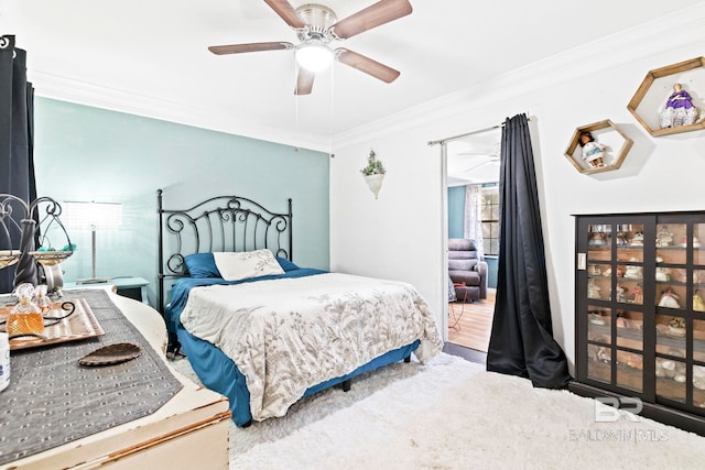 bedroom with ceiling fan, carpet floors, and ornamental molding