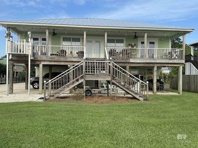 rear view of property featuring french doors, a yard, and stairway