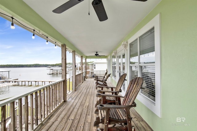 wooden terrace featuring a water view and ceiling fan