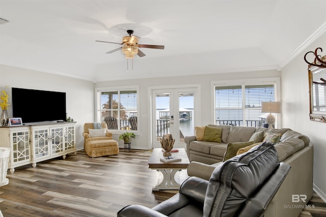 living area with ornamental molding, french doors, a healthy amount of sunlight, and wood finished floors