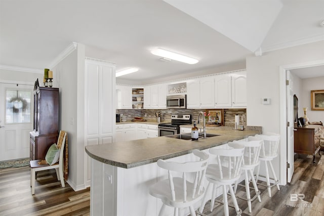 kitchen with open shelves, appliances with stainless steel finishes, and white cabinetry