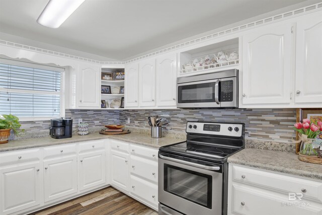 kitchen with open shelves, appliances with stainless steel finishes, and white cabinetry