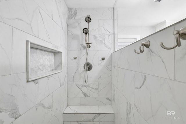 bathroom with a tile shower