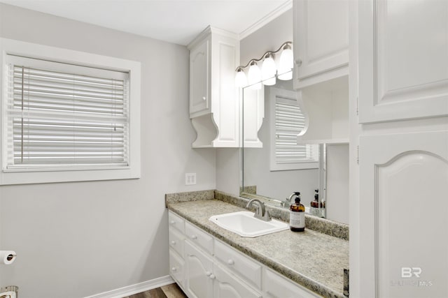 bathroom with vanity and baseboards
