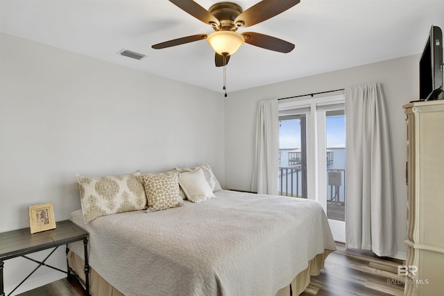 bedroom with access to outside, visible vents, ceiling fan, and wood finished floors