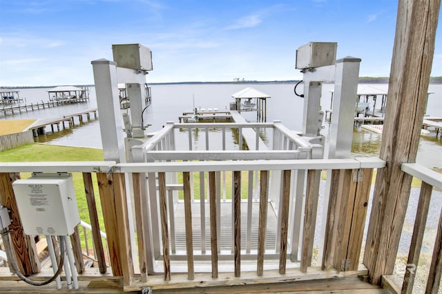 deck featuring a boat dock, a water view, and boat lift