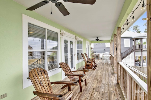 wooden deck with ceiling fan and french doors