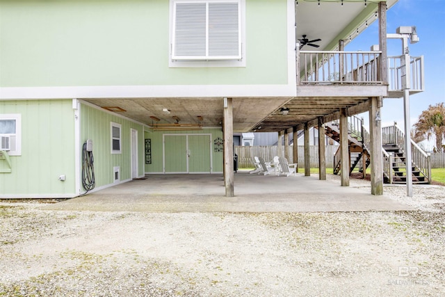 exterior space featuring a carport, ceiling fan, and dirt driveway
