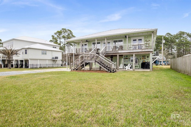 exterior space featuring stairs, a yard, fence, and driveway