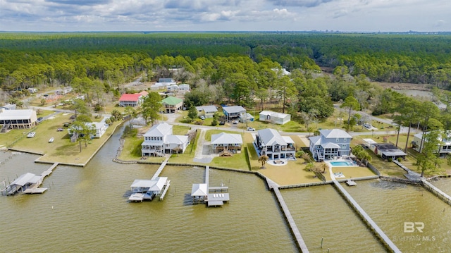 aerial view featuring a water view, a residential view, and a wooded view