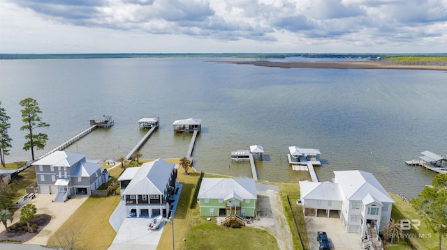 birds eye view of property with a water view and a residential view