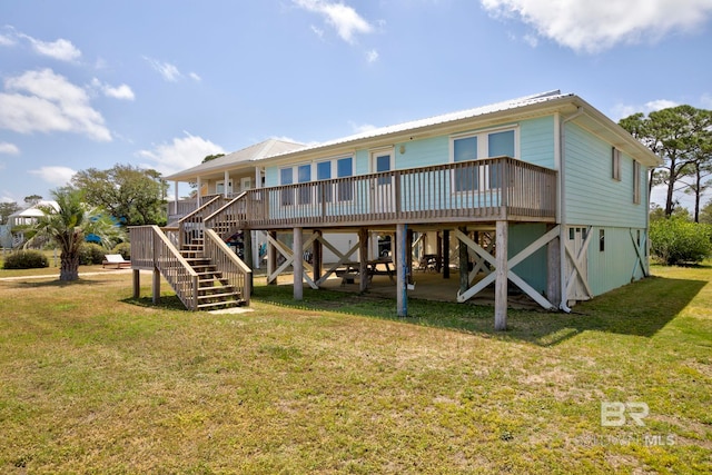 8239 Gulf Beach Ln, Gulf Shores, AL 36542 - rear view of property with a yard, metal roof, stairs, and a wooden deck