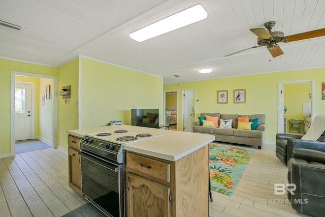 8239 Gulf Beach Ln, Gulf Shores, AL 36542 - kitchen featuring range with electric stovetop, light countertops, baseboards, light wood finished floors, and open floor plan