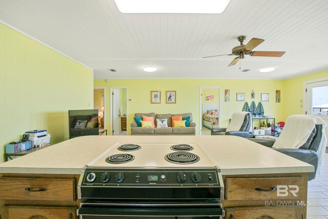 8239 Gulf Beach Ln, Gulf Shores, AL 36542 - kitchen featuring electric range, light countertops, brown cabinetry, a ceiling fan, and open floor plan