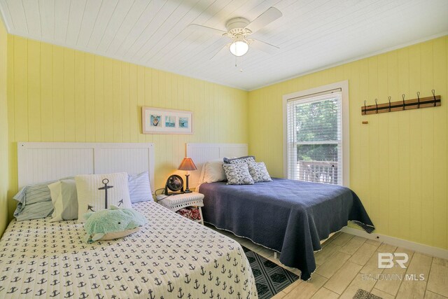 8239 Gulf Beach Ln, Gulf Shores, AL 36542 - bedroom featuring wood ceiling, a ceiling fan, wood finished floors, baseboards, and wooden walls