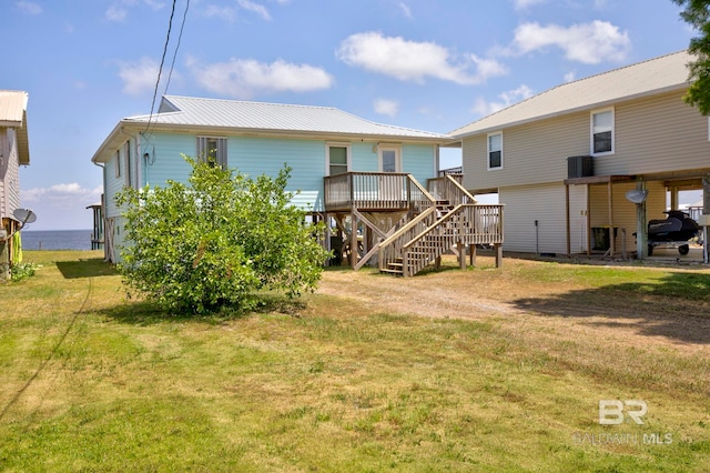 8239 Gulf Beach Ln, Gulf Shores, AL 36542 - back of house featuring a wooden deck, metal roof, a yard, and stairway
