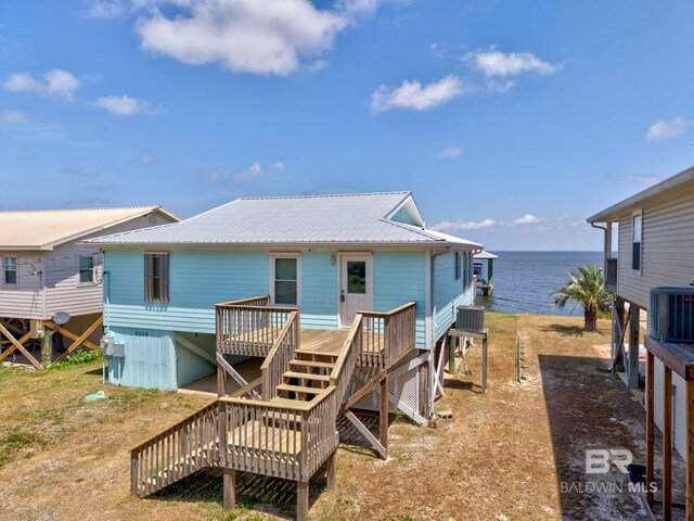 8239 Gulf Beach Ln, Gulf Shores, AL 36542 - rear view of property featuring a deck with water view, metal roof, cooling unit, and stairway