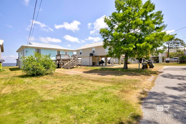 8239 Gulf Beach Ln, Gulf Shores, AL 36542 - view of yard featuring a deck and stairway
