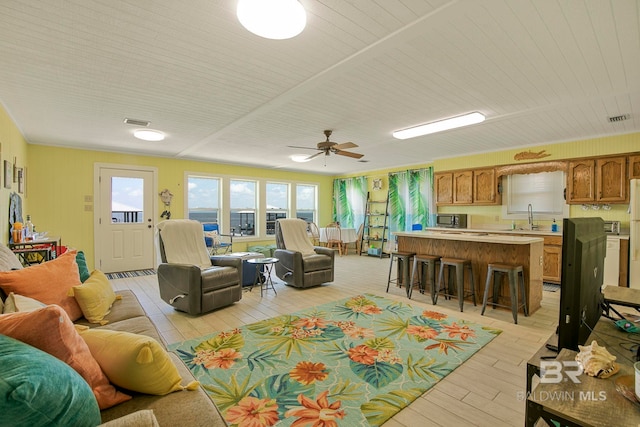 8239 Gulf Beach Ln, Gulf Shores, AL 36542 - living area featuring light wood-style floors, a ceiling fan, and visible vents